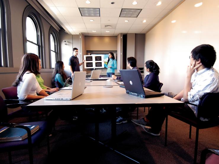 students sitting around a table speaking