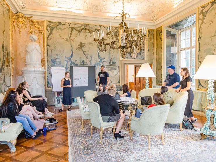 Students sitting and interacting in a hall 