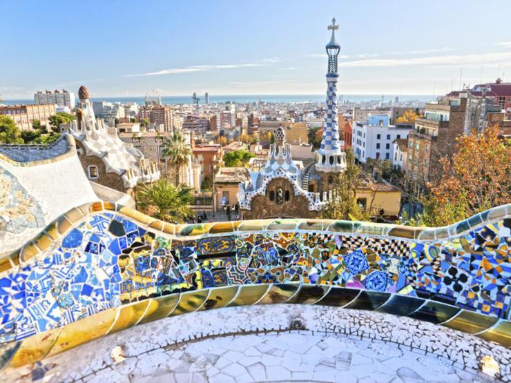 Park Güell in Barcelona with colorful outdoor architecture during the day.