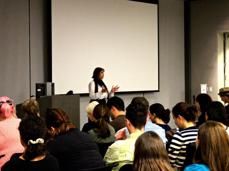 A woman speaking to an audience of students