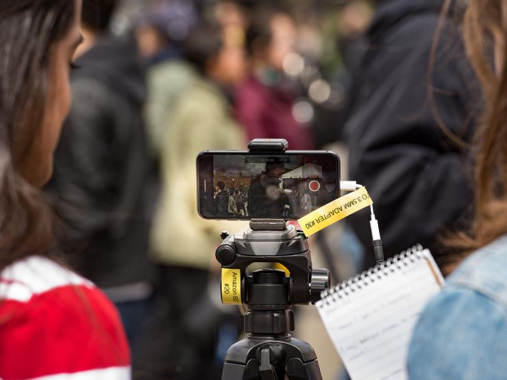 journalism students film and take notes 