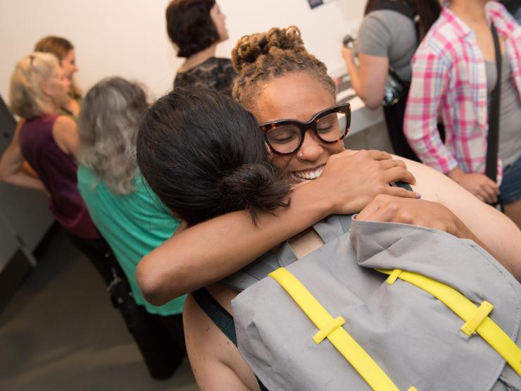 Two students embrace at an orientation event