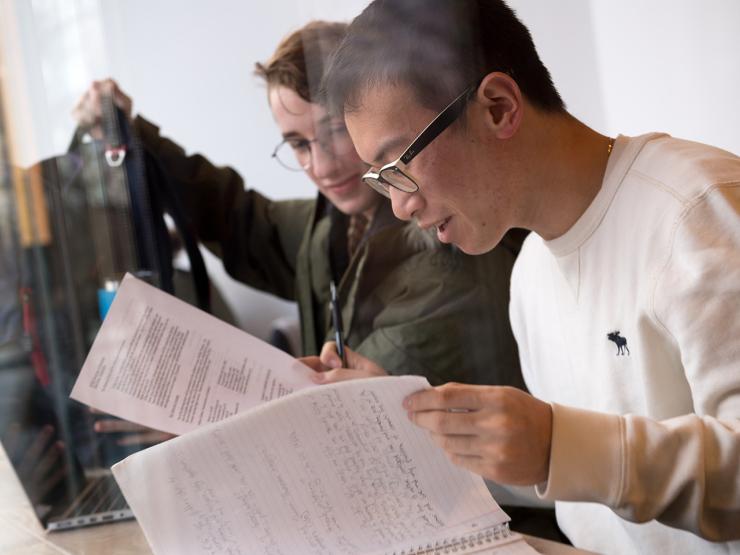 Two students looking at homework assignments