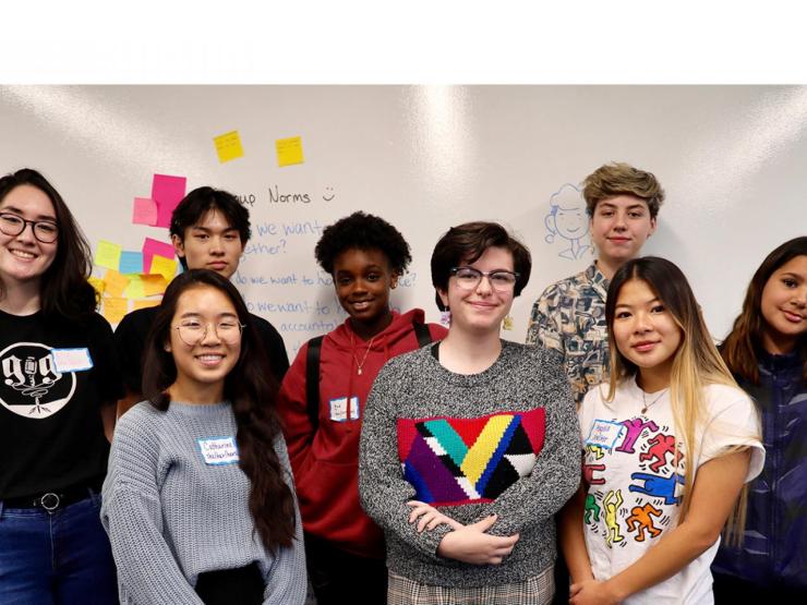 Group of people standing and smiling at the camera