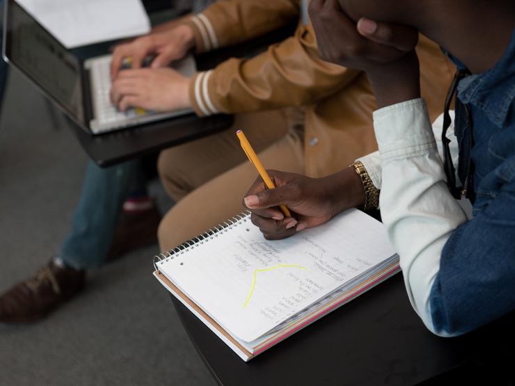 Student writing in a notebook