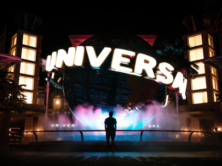 Person standing in front of Universal Studios fountain