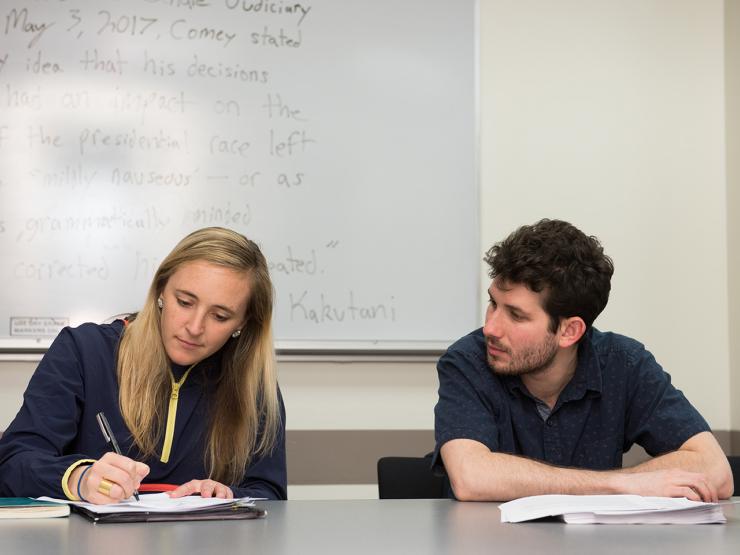 Two students sitting next to each other in a creative writing graduate class