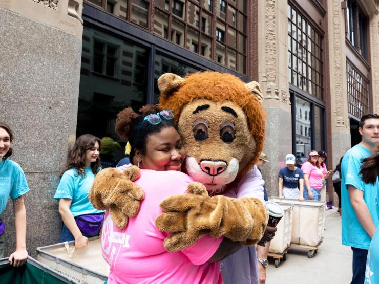 Student hugging Griff the Lion