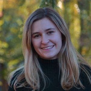 Kimberly O'Donnell standing in front of trees