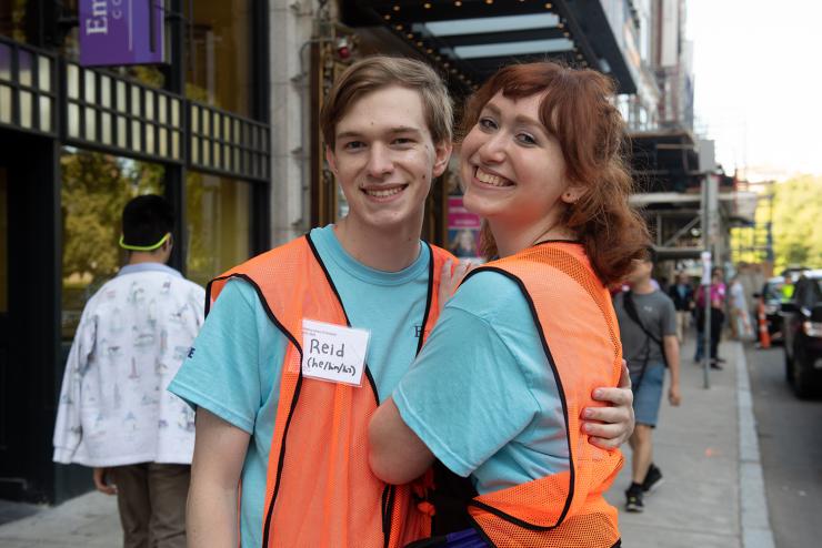 Residence assistants wearing orange vests hugging