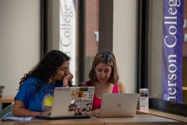 Two students working on their laptops