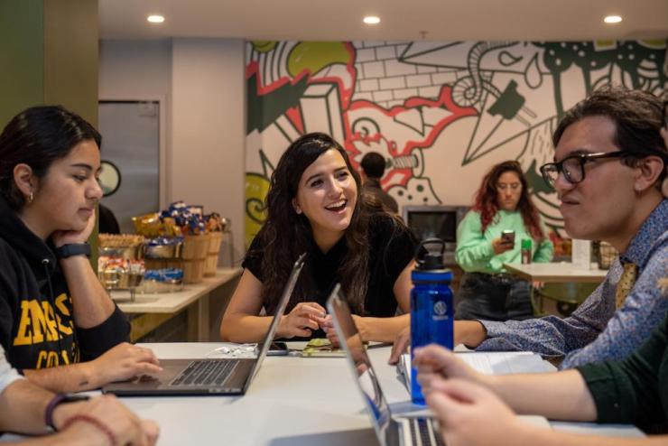 Students talking and working on computers