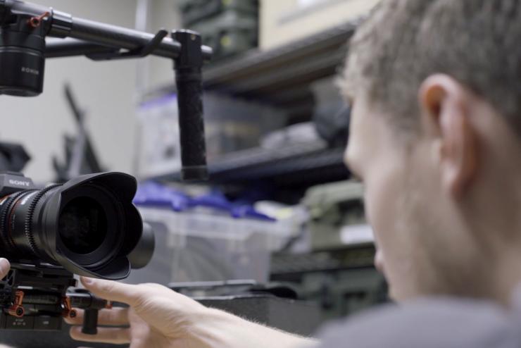 Staff puts a Sony camera on a gimbal for stabilization