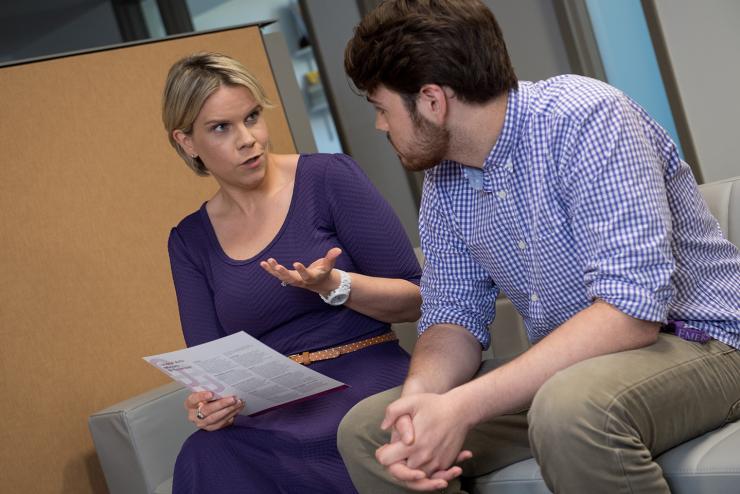 Student and staff member sitting and talking in the Academic Advising Center