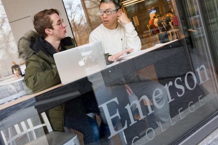 two students sitting in the dining hall