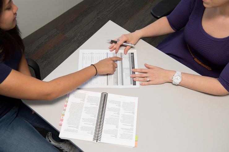 two people working on a form