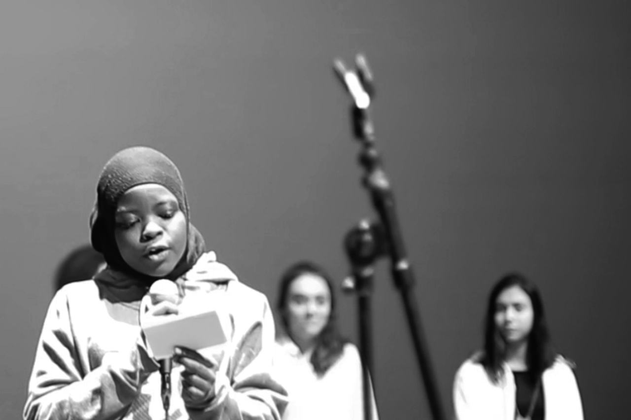 Image of a student reading a poem